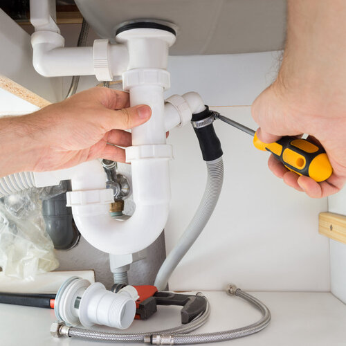 close-up of a plumber repairing a bathroom sink