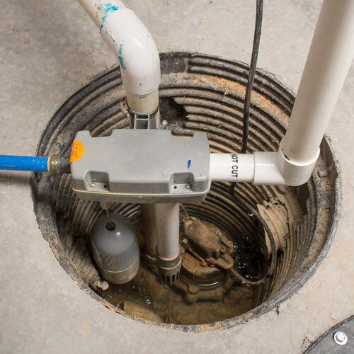 a plumbing pump in a basement pit