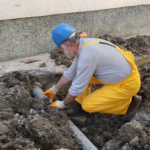 plumber working on a sewer line